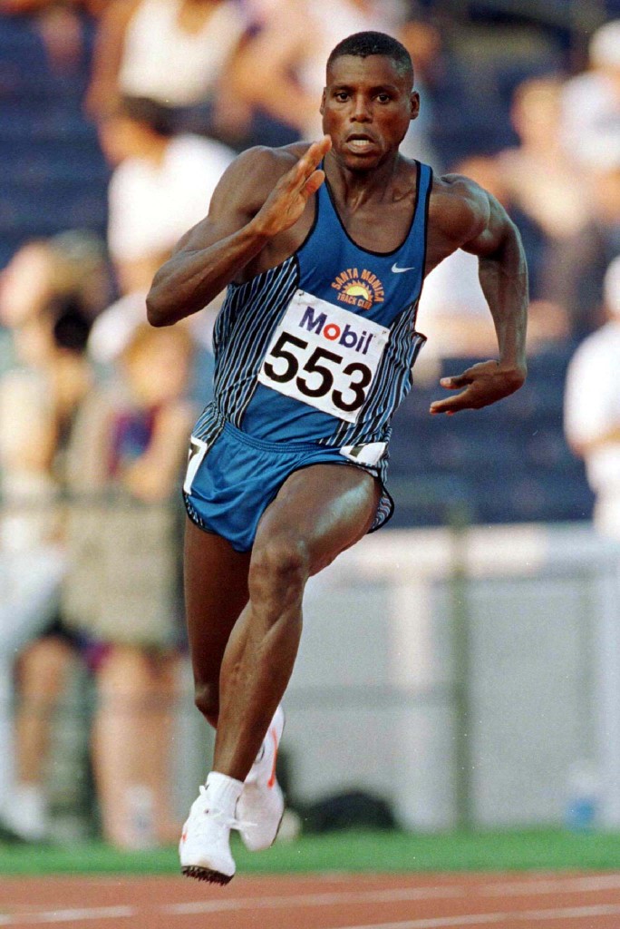 Carl Lewis races through a turn during his heat in the first round of