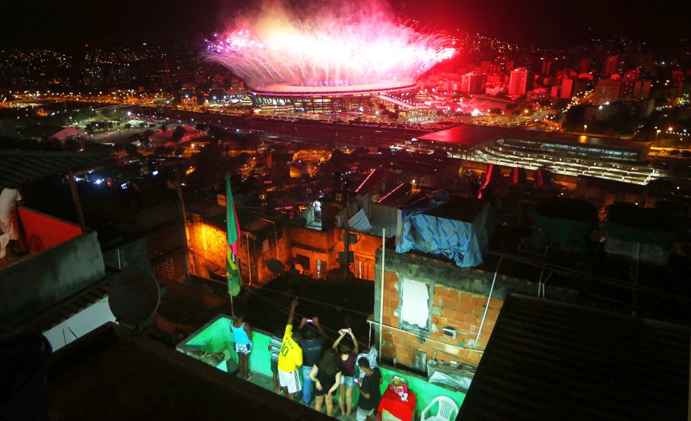 RIO DE JANEIRO, BRAZIL - AUGUST 05: Fireworks explode over Maracana stadium with the Mangueira 'favela' community in the foreground during opening ceremonies for the Rio 2016 Olympic Games on August 5, 2016 in Rio de Janeiro, Brazil. The Rio 2016 Olympic Games commenced tonight at the iconic stadium. (Photo by Mario Tama/Getty Images)